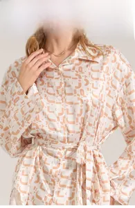 Detail view of printed satin pajama top with notched collar and button closure