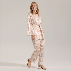 Women's 2-piece cream satin pajama set with orange geometric print and long sleeves