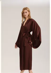 Detail view of smooth dark brown satin robe showing elegant draped sleeves and tie waist