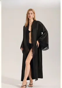 Detailed view of long black satin nightdress with elegant lace trim and smooth finish