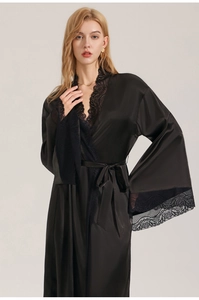 Close-up detail of luxurious black satin nightdress with delicate lace trim on sleeves