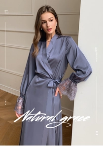 Detail of grey-blue satin robe showing delicate lace trim on sleeves and elegant belt tie