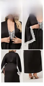 Detailed view of black satin bathrobe with elegant white lace trim and smooth texture