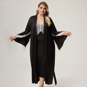 Detail of elegant black satin robe with intricate white lace sleeves and matching inner dress