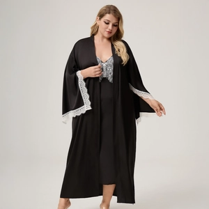 Detail of elegant black satin robe with intricate white lace trim on sleeves and chest
