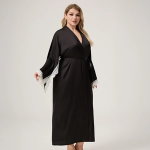 Detail of elegant black satin robe featuring wide white eyelash lace trim on long sleeves