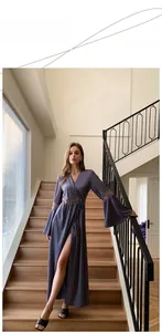 Detail of elegant satin loungewear showing lace stitching and flared sleeves in mauve