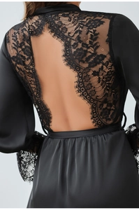 Close-up of the elegant open back design with floral eyelash lace trim on satin robe