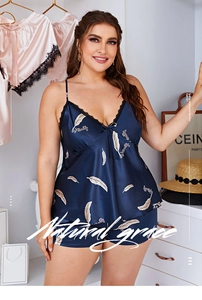 Detail of plus size navy satin pajamas featuring feather print and lace V-neck trim