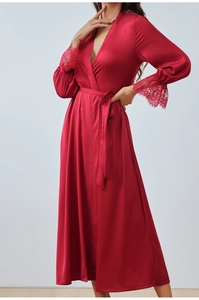 Detail of red satin robe showing exquisite lace cuffs and luxurious silk texture