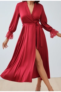 Close-up of deep red satin robe featuring elegant lace cuffs and matching waist tie belt