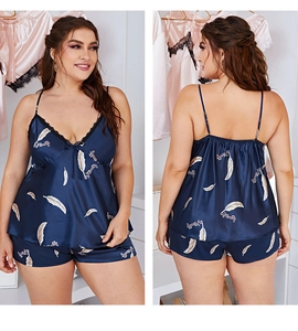 Detail view of satin plus size pajama set with lace neckline and feather patterns