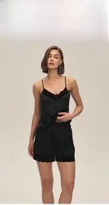 Detailed view of women's black satin sleepwear set with delicate lace trim on camisole and shorts