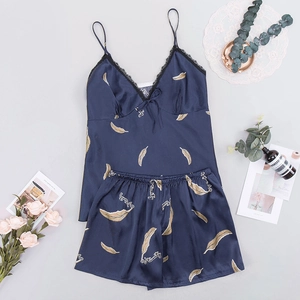 Flat lay of blue satin pajama set with golden feather prints and black lace details