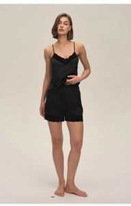 Detailed close-up of black satin women's pajamas with delicate lace trim on hem and neckline