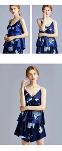 Detail of dark blue silk satin pajamas with lace trim and bird print pattern