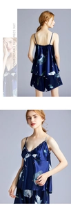 Detail of crane print on navy blue satin sleepwear set with delicate lace trim