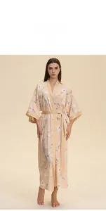 Detail of pink satin floral robe featuring long sleeves and an adjustable waist tie