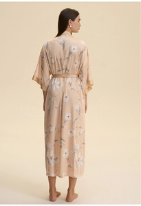 Detail of elegant satin long robe featuring white floral prints and a matching waist belt