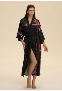 Detail view of a black satin robe with red plum blossom patterns and waist belt tie