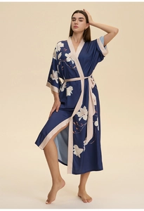 Detailed view of the elegant satin silk robe with white magnolia floral print on navy fabric