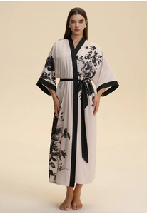 Detail of floral satin robe with black trim collar and matching waist belt tie