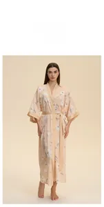 Detail of floral satin robe featuring high-quality silky fabric and elegant sleeve hem