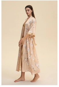 Detail of floral satin long robe with white flowers and blue leaves on warm beige silk