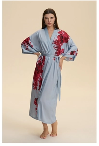 Detailed view of light blue satin kimono robe with bold red floral patterns and belted waist