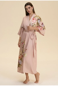 Detail of pink floral satin long bathrobe with soft rose print and matching waist tie