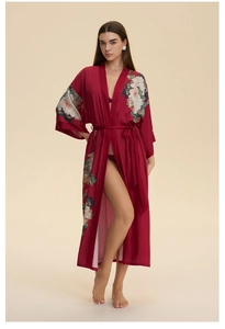 Detailed view of floral prints on wine red satin bathrobe with silky fabric texture