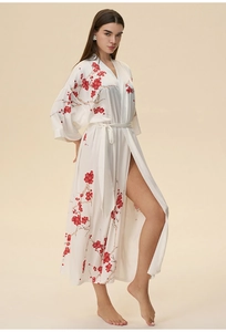 Detail of white satin robe with red plum blossom print and waist tie closure