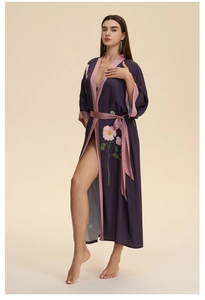 Detail of plum silk satin robe showing floral print, pink trim and soft fabric texture