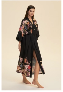 Detail of black satin floral robe showing premium fabric texture and elegant flower print