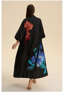 Detailed back view of a black satin robe featuring elegant large floral prints and silk texture