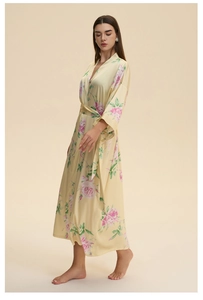 Detailed view of pale yellow satin floral robe featuring elegant pink rose patterns