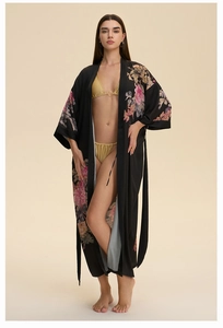 Full view of black satin floral kimono robe with golden yellow bikini on a model
