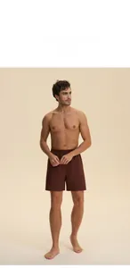Men's dark brown cotton lounge shorts with elastic waistband shown on model