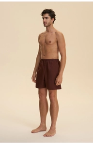 Detail of dark brown men's sleep shorts with elastic waistband and soft drape fabric