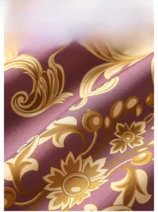 Macro detail of purple textile fabric with gold Baroque floral patterns and twill texture