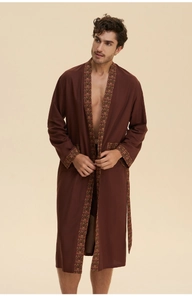 Detail of men's brown cotton robe with ethnic patterned cuffs and pocket trim accents