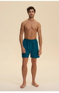 Detailed view of dark teal men's cotton lounge shorts with comfortable elastic waistband