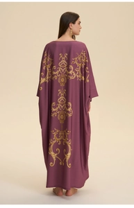 Rear view of long purple caftan dress featuring intricate golden baroque floral prints