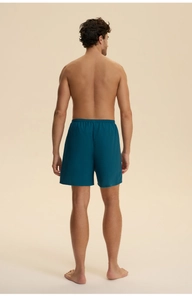 Detail view of men's dark teal cotton shorts with an elastic waistband and casual fit