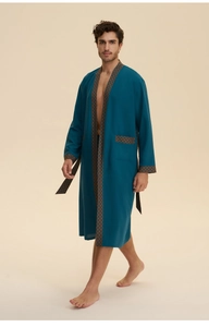 Detail of teal cotton bathrobe showing the geometric patterned trim and waist tie
