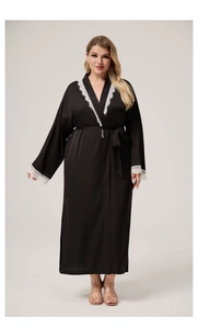 Detail of black satin long robe with delicate white lace embroidery on cuffs and neckline