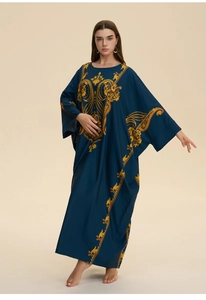 Detail of loose navy blue kaftan featuring yellow paisley print and batwing sleeves