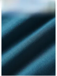 Close-up of deep blue cotton fabric material showing fine weave texture and matte finish
