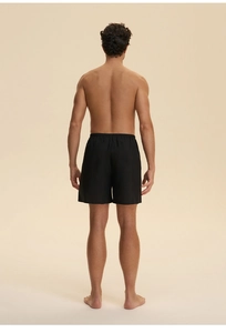 Rear view of men's black lightweight cotton lounge shorts with an elastic waist band