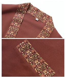 Detail view of reddish-brown robe showing floral pattern collar and size M label